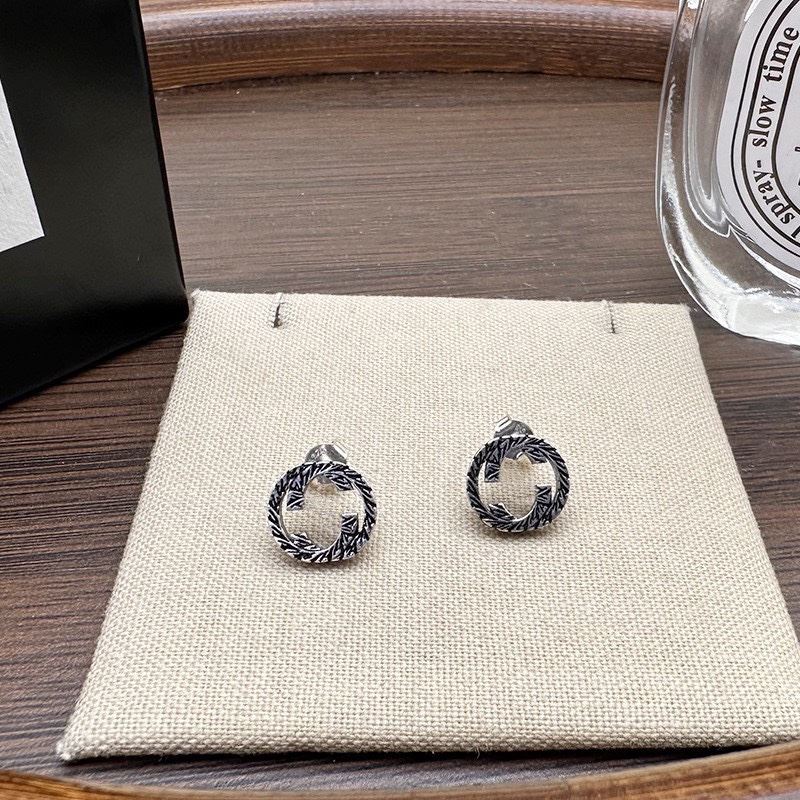 G*u*i earrings